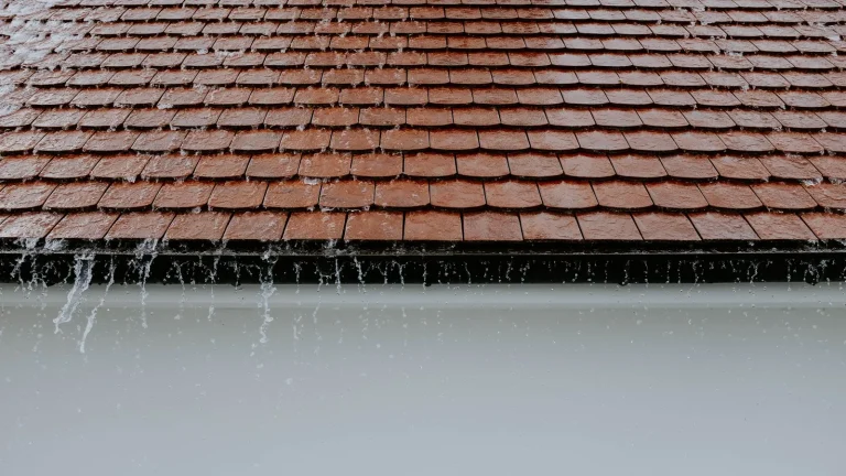 Rain running off a roof edge into the gutter line, gutter installation in Duluth, MN