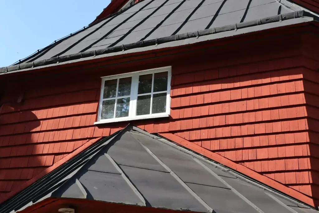 Home with a dark standing seam metal roof