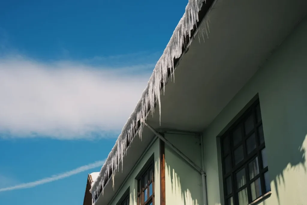 Icicles forming along the eaves of a house in winter