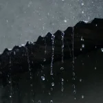 Water running off a roof edge